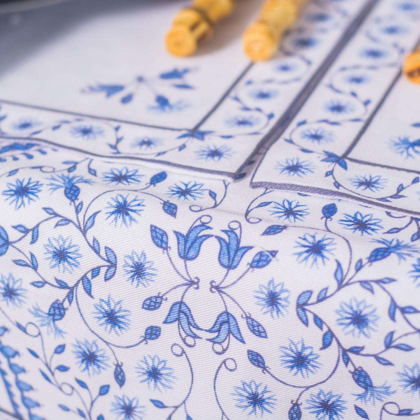 Close-up of blue floral patterns on white napkins and placemats