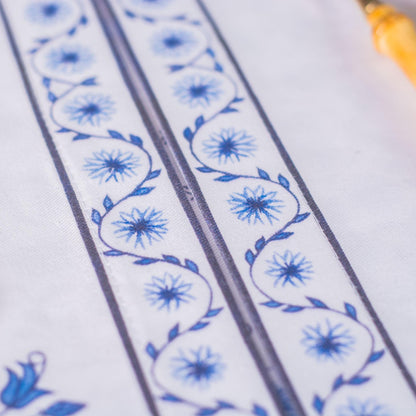Close-up of a cotton placemats with blue floral patterns on a white background