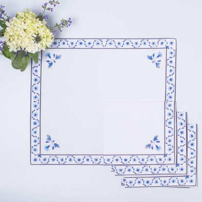 Decorative tablecloth with blue floral patterns on a light purple background